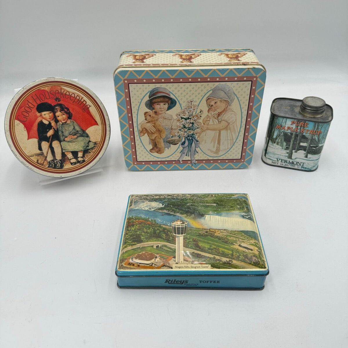 Lot of 4 Collectible Tins Niagra Falls Vermont Maple Syrup Good Housekeeping USA